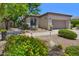 Charming single-story home featuring well-maintained landscaping, desert flora, and a two-car garage at 7128 E Bramble Berry Ln, Scottsdale, AZ 85266