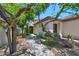 Beautiful single-story home surrounded by lush desert landscaping and mature trees at 7128 E Bramble Berry Ln, Scottsdale, AZ 85266