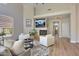 Bright living room boasts a fireplace, TV, and access to other parts of the house at 7128 E Bramble Berry Ln, Scottsdale, AZ 85266