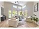 Spacious living room with a ceiling fan, lots of light, and stylish furniture arrangement at 7128 E Bramble Berry Ln, Scottsdale, AZ 85266