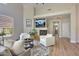 Bright living room boasts a fireplace, TV, and access to other parts of the house at 7128 E Bramble Berry Ln, Scottsdale, AZ 85266
