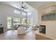 Spacious living room with a ceiling fan, lots of light, stylish furniture and fireplace at 7128 E Bramble Berry Ln, Scottsdale, AZ 85266