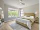 Spacious main bedroom features neutral tones, ceiling fan, and backyard views at 7128 E Bramble Berry Ln, Scottsdale, AZ 85266
