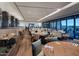 An inviting, spacious restaurant with modern décor, a variety of seating, and large windows with scenic views at 7128 E Bramble Berry Ln, Scottsdale, AZ 85266