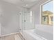 Bathroom featuring a clear glass shower, soaking tub, and neutral paint at 7492 E Via De Luna Dr, Scottsdale, AZ 85255