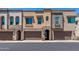 Modern townhomes with attached garages, neutral stucco, and arched entryways exude contemporary charm at 7492 E Via De Luna Dr, Scottsdale, AZ 85255