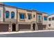 Modern townhomes with attached garages, neutral stucco, and arched entryways exude contemporary charm at 7492 E Via De Luna Dr, Scottsdale, AZ 85255