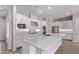 Bright white kitchen with modern appliances, large island, white quartz counters, and hexagon backsplash at 7492 E Via De Luna Dr, Scottsdale, AZ 85255