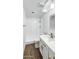 This bathroom features a shower, wood-look floors, and a sink with a modern faucet at 7730 W Mulberry Dr, Phoenix, AZ 85033