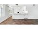Open living space showcasing the kitchen bar, and living area with a fireplace at 7730 W Mulberry Dr, Phoenix, AZ 85033