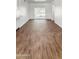 Open living space with neutral walls and wood-look tile floors, plus sliding glass doors to the exterior at 7730 W Mulberry Dr, Phoenix, AZ 85033