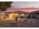 A spacious backyard with a play structure, grill, and beautiful sunset view at 8132 E Onza Ave, Mesa, AZ 85212