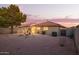 A spacious backyard with a play structure, grill, and beautiful sunset view at 8132 E Onza Ave, Mesa, AZ 85212