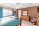Warm bedroom with carpet, wooden furniture, bright window and light blue bedding at 8132 E Onza Ave, Mesa, AZ 85212