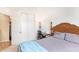 Cozy bedroom featuring neutral walls, closet, desk, and wooden-framed bed with light blue bedding at 8132 E Onza Ave, Mesa, AZ 85212