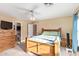 Well lit bedroom featuring neutral walls, carpet, wooden furniture and access to a bathroom at 8132 E Onza Ave, Mesa, AZ 85212