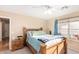 Sunny bedroom featuring neutral walls, carpet, wooden furniture and a bright window at 8132 E Onza Ave, Mesa, AZ 85212