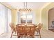 Cozy dining room featuring a wooden table with seating for six and natural light at 8132 E Onza Ave, Mesa, AZ 85212