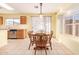 Cozy dining room featuring a wooden table with seating for six and natural light at 8132 E Onza Ave, Mesa, AZ 85212