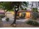 Charming single-story home with desert landscaping, featuring a 2-car garage and a welcoming front entrance under a pink sky at 8132 E Onza Ave, Mesa, AZ 85212