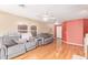 Bright living room with hardwood floors, ceiling fan and large sofas at 8132 E Onza Ave, Mesa, AZ 85212