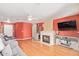 Bright living room with hardwood floors, a cozy fireplace and a large sofa at 8132 E Onza Ave, Mesa, AZ 85212