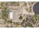 Top down aerial view of home featuring a pool, patio, desert landscaping, and circular driveway at 8698 E Preserve Way, Scottsdale, AZ 85266