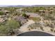 Expansive aerial view of a well-maintained home, boasting a circular driveway and desert landscaping at 8698 E Preserve Way, Scottsdale, AZ 85266