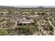 Back aerial view of a home with a desert backyard, pool, patio, and chairs at 8698 E Preserve Way, Scottsdale, AZ 85266