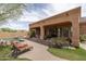 Inviting backyard with covered patio, pool, spa, outdoor seating, and desert landscaping at 8698 E Preserve Way, Scottsdale, AZ 85266