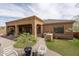 Spacious backyard with covered patio, built-in grill area, artificial turf, and desert landscaping at 8698 E Preserve Way, Scottsdale, AZ 85266