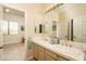 Well-lit bathroom features dual sinks and views into an adjacent room and natural light at 8698 E Preserve Way, Scottsdale, AZ 85266