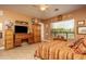 Warm bedroom with a striped bedspread, wooden furniture and decor, and bright natural light at 8698 E Preserve Way, Scottsdale, AZ 85266