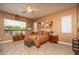 Bright bedroom with a comfortable bed, vintage chest, and natural light from multiple windows at 8698 E Preserve Way, Scottsdale, AZ 85266