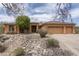 Warm, inviting home featuring a three-car garage and desert landscaping at 8698 E Preserve Way, Scottsdale, AZ 85266