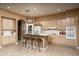 Open kitchen featuring a breakfast bar with seating and white appliances at 8698 E Preserve Way, Scottsdale, AZ 85266