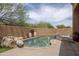 Tranquil pool area with rock features, desert landscaping, and a spa with a soothing waterfall at 8698 E Preserve Way, Scottsdale, AZ 85266