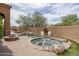 Backyard with a pool and two tiered spa featuring a waterfall, desert landscaping, and a fire pit at 8698 E Preserve Way, Scottsdale, AZ 85266