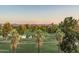 Scenic aerial view showcasing the lush golf course, pond, and distant city skyline at 914 E Osborn Rd # 404, Phoenix, AZ 85014