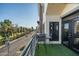Balcony view featuring turf, seating and a street view framed by tall palm trees at 914 E Osborn Rd # 404, Phoenix, AZ 85014