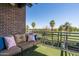 Relaxing balcony featuring comfortable seating with a golf course and palm tree view at 914 E Osborn Rd # 404, Phoenix, AZ 85014