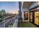 Relaxing balcony featuring artificial turf and cityscape views with palm trees at sunset at 914 E Osborn Rd # 404, Phoenix, AZ 85014