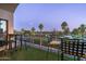 Balcony overlooking a golf course, with seating and a view of palm trees at dusk at 914 E Osborn Rd # 404, Phoenix, AZ 85014