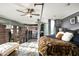 Bedroom featuring high ceilings, exposed brick wall, ceiling fan, and an industrial modern aesthetic at 914 E Osborn Rd # 404, Phoenix, AZ 85014