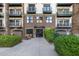 Elegant building entrance featuring a brick facade, modern doors, and well-maintained landscaping at 914 E Osborn Rd # 404, Phoenix, AZ 85014