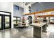Open-concept dining room with a wood table, exposed beams, and a view into the gourmet kitchen at 914 E Osborn Rd # 404, Phoenix, AZ 85014