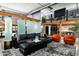 Open-concept living space with a modern sofa, accent chairs, and views of the upstairs area at 914 E Osborn Rd # 404, Phoenix, AZ 85014