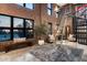 A bright living room shows a ladder for access to high windows, exposed brick, and modern furniture at 914 E Osborn Rd # 404, Phoenix, AZ 85014