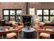 Elegant living room with exposed brick wall, fireplace, and stylish seating arrangement at 914 E Osborn Rd # 404, Phoenix, AZ 85014