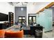 Bright living room with plush black leather seating, unique decor, and views to the outdoors at 914 E Osborn Rd # 404, Phoenix, AZ 85014